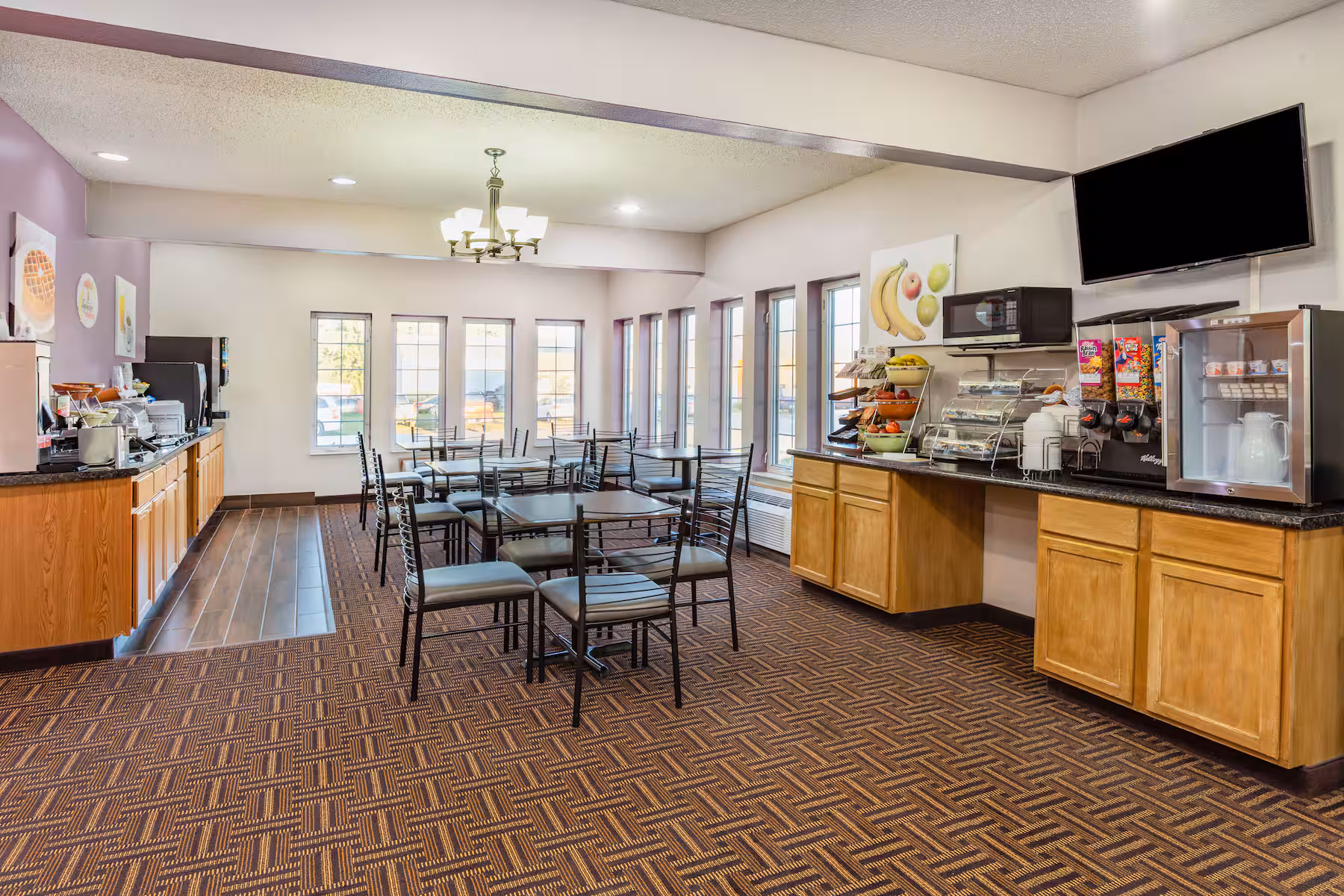 Bright breakfast and dining area with natural light at Emmetsburg Hotel & Suites